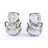 A pair of large Portuguese Palissy style vases profusely decorated with applied flowers and birds,