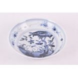 A 18th century Kangxi Chinese porcelain saucer the shallow bowl decorated with blue underglaze