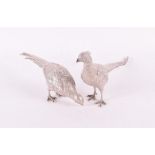 A pair of finely cast silver pheasants London 1990, and APRP maker's mark, realistically modelled,