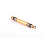 Cartier; an Art Deco yellow metal telescopic propelling pencil in black enamelled case, the pencil