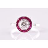 A diamond and ruby target ring in the Art Deco style, centred with a round brilliant-cut diamond