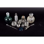 A small collection of silver lidded cut glass dressing table bottles together with a silver