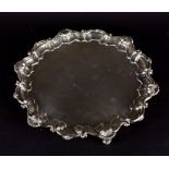 A large Edwardian silver salver Birmingham 1904, by Barker Brothers, of shaped form with scroll