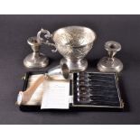 A small group of silver items to include a cased set of silver spoons, a pair of weighed silver