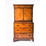 A William & Mary period mahogany and walnut cabinet on chest formed of a chest of three drawers