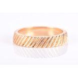 Kutchinsky. An 18ct yellow gold eternity band of sloped design, with ribbed design all round,