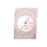 A ladies white gold Longines watch hallmarked 375, with white baton dial and diamond set bezel,