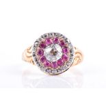 A late 19th / early 20th century gold, diamond, and ruby cluster ring centred with an old rounded