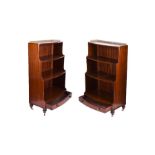A pair of early 20th century waterfall bookcases with four fixed graduated shelves, pierced brass