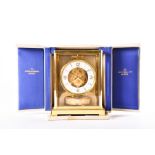 A Jaeger-LeCoultre 'Atmos' clock, in a lacquered brass case, with a circular white dial, serial