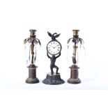 A small Regency style clock garniture with central clock modelled as a man holding the dial above,