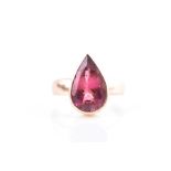 A 9ct yellow gold and pink tourmaline ring set with a mixed pear-cut pink tourmaline measuring