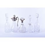 A collection of crystal decanters to include a claret jug with silver plate mount, a decanter with