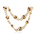 A yellow gold knotted fancy-link chain necklace approximately 78 cm long, marked 'K18', 'Italy' to