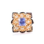 An unusual 18ct yellow gold, diamond, sapphire, and enamel ring the squared openwork mount centred