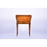 A Regency walnut compendium table with drop ends, the central part lifting to reveal a sewing