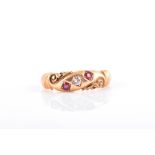 A late Victorian 18ct yellow gold gypsy ring set with a small old-cut diamond and two ruby paste