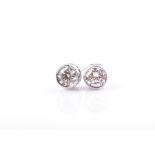 A pair of 18ct white gold and diamond solitaire ear studs bezel set, the round brilliant-cut