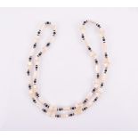 A mother-of-pearl, crystal, and glass bead necklace of opera length, with rounded and faceted