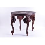 An early 20th century Indian carved hardwood occasional table the oval top decorated with flora
