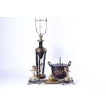 An early 20th century Empire style toleware lamp together with a pair of candlesticks with green