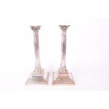 A pair of 19th century German silver candlesticks each marked 800, the bodies modelled as corinthian