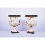 A large pair of Classical style garden Medici urns each flanked with twin handles with masks and