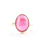 An 18ct yellow gold and tourmaline ring set with an oval cabochon pink tourmaline, measuring