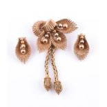 Kutchinsky. A 9ct yellow gold foliate brooch of palm frond and seeded form, with two tassle drops,