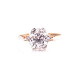 A 9ct yellow gold and cubic zirconia ring set with a cluster of round-cut stones, size N, 1.8