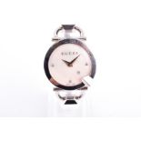 A Gucci Chiodo ladies stainless steel wristwatch the engraved mother-of-pearl dial with date