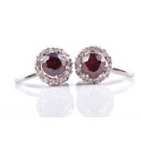A pair of 18ct white gold, diamond, and garnet earrings of circular cluster form, approximate