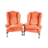 A pair of George Smith wingback armchairs upholstered with red and yellow paisley pattern fabric