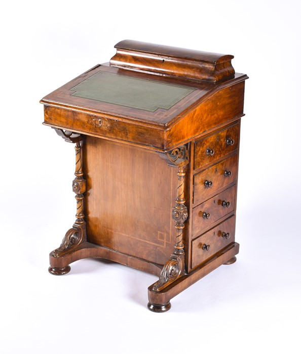 A Victorian burr walnut Davenport the string inlaid top with lifting lid to reveal compartments