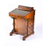 A Victorian burr walnut Davenport the string inlaid top with lifting lid to reveal compartments