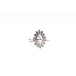 A 14ct white gold and cubic zirconia cluster ring set with a marquise-shaped CZ surrounded by