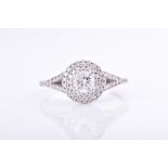 A diamond double halo ring centred with a round brilliant-cut diamond of approximately 0.45