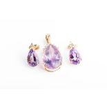 A yellow metal, diamond, and amethyst pendant set with a pear-cut amethyst with a surmount of