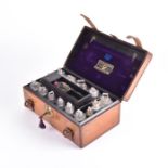 A late 19th century leather cased apothecary set by Treacher & Co the inside of the lid with