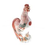 A Chinese Kangxi period famille verte porcelain model of a cockerel painted with iron red, green,