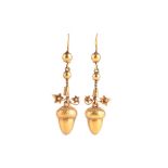 A pair of 19th century gold earrings  suspended with hollow acorn drops, beneath ornate stylised