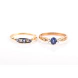 A 9ct yellow gold, diamond and sapphire ring set with an oval-cut sapphire, two small diamonds and