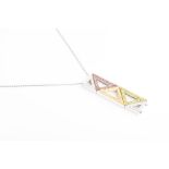 An unusual white gold, diamond, pink and yellow sapphire, and demantoid garnet pendant of abstract
