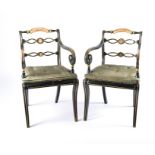 A pair of Regency style green painted chairs decorated with withe and gilded lines, scrolling