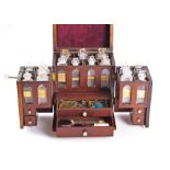 A Regency period mahogany medicine chest of cube form with a rising cover and two winged doors,