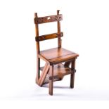 An early 20th century oak metamorphic library chair with pierced Gothic style decoration, 39 cm wide