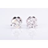 A pair of round brilliant-cut solitaire diamond ear studs the two diamonds of approximately 1.10