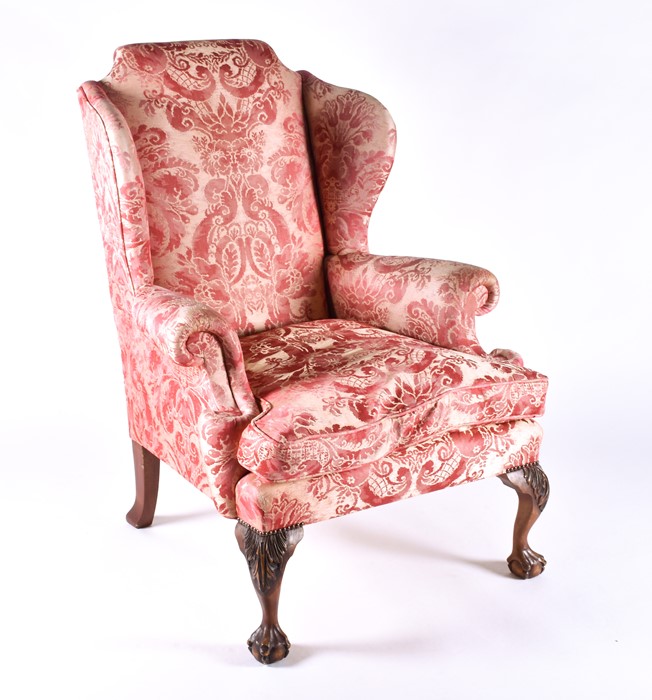 An English upholstered wingback armchair with pink rococo design fabric with studded metal detail to - Image 2 of 5