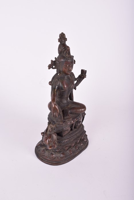 A South East Asian bronze deity, possibly Tara the goddess sits above a crouching guardian, raised - Image 3 of 5
