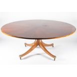 A large mahogany veneered circular dining table early 20th century, on a pedestal base with four